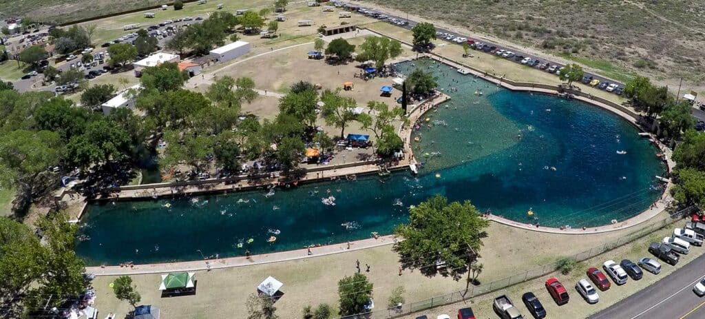 Aerial view of the spring-fed swimming pool at Balmorhea State Park in West Texas, surrounded by the Chihuahuan Desert.