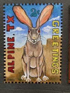 A mural of a postage stamp with a jackrabbit and words that say Greetings Alpine TX