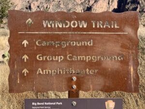 A directional sign for the Window Trail at Big Bend National Park. It also gives direction to the campground and amphitheater.