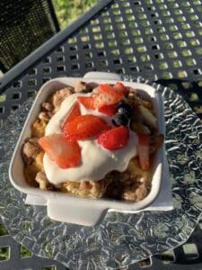 Strawberry bread pudding with yogurt maple sauce and fresh berries