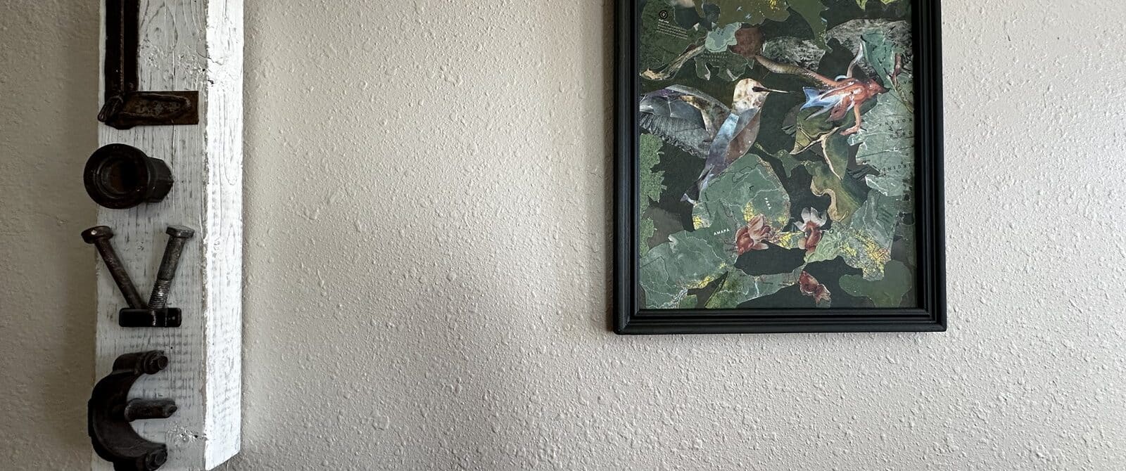 Two pieces of wall art, one says love and one is a picture of a hummingbird