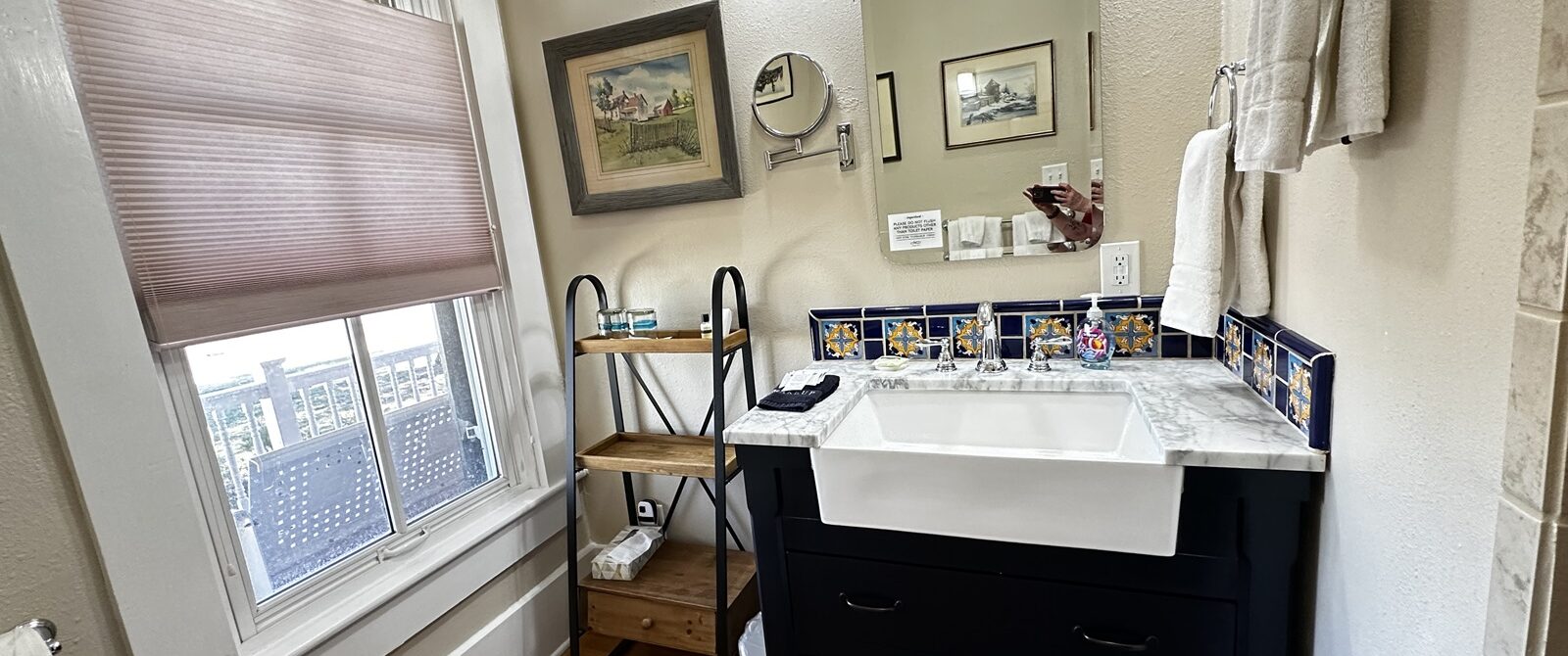 bathroom with large vanity and window with lots of sunlight