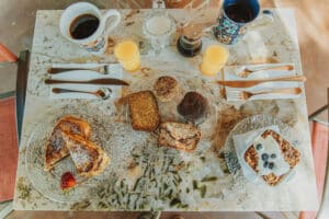 Breakfast for two with french toast, baked oats, coffe, juice, homemade breads