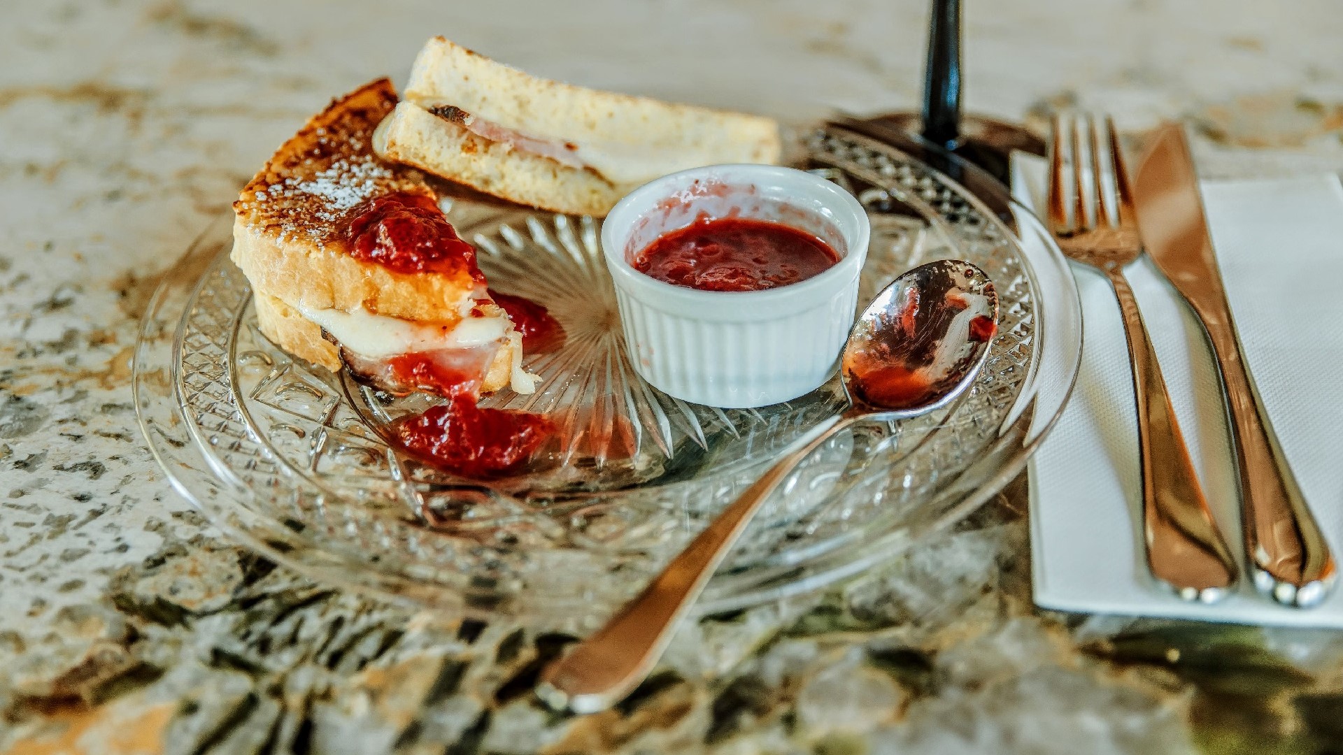 monty cristo sandwich with french toast, ham, swiss, strawberry compote