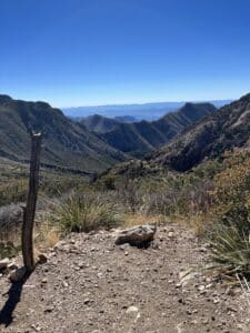 View of desert mountains for miles with blues, greens and browns