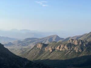 A long distance view of green mountains and blue skies