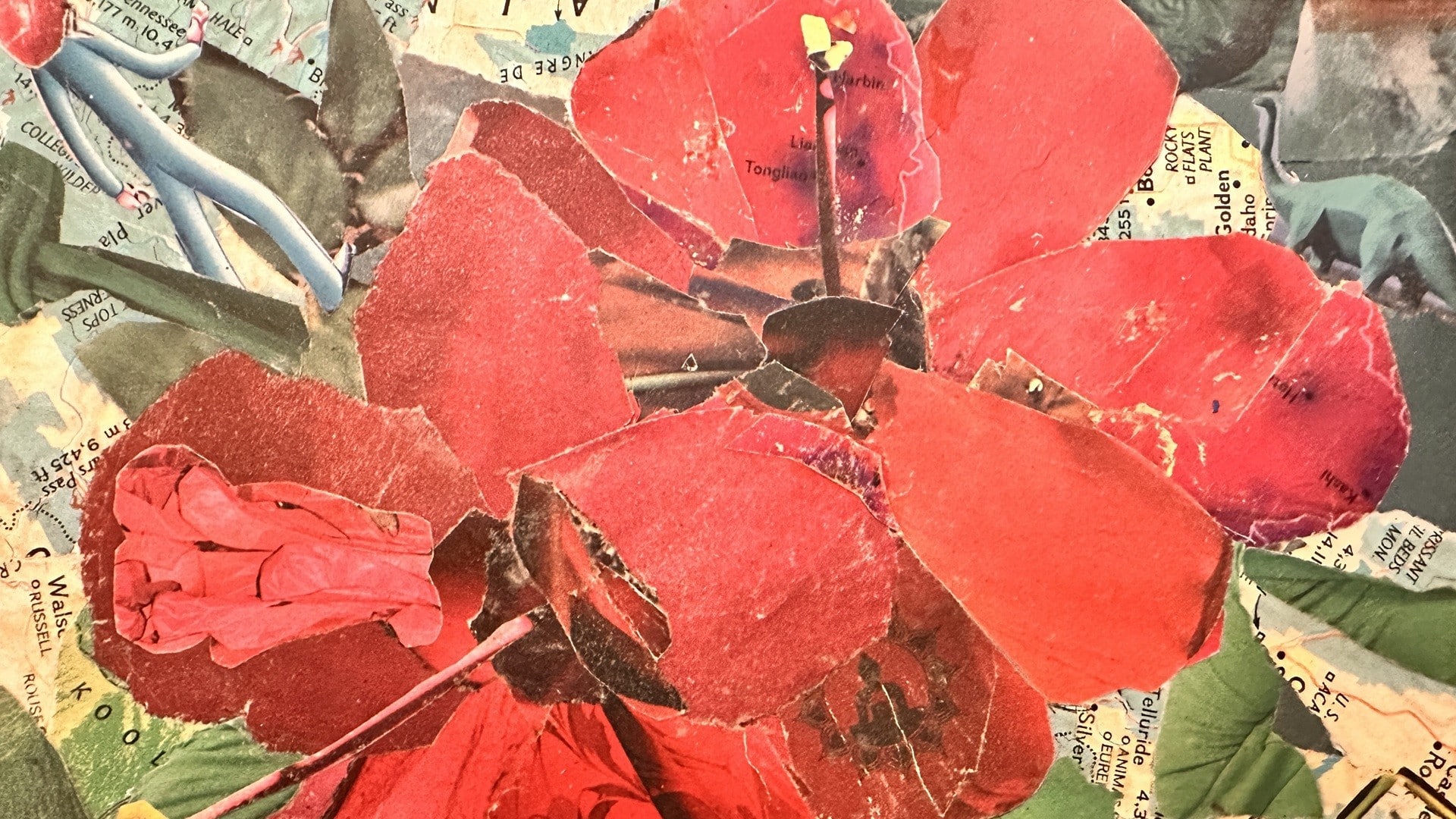 Mixed media art of a red hybiscus made out of torn maps and magazine photos