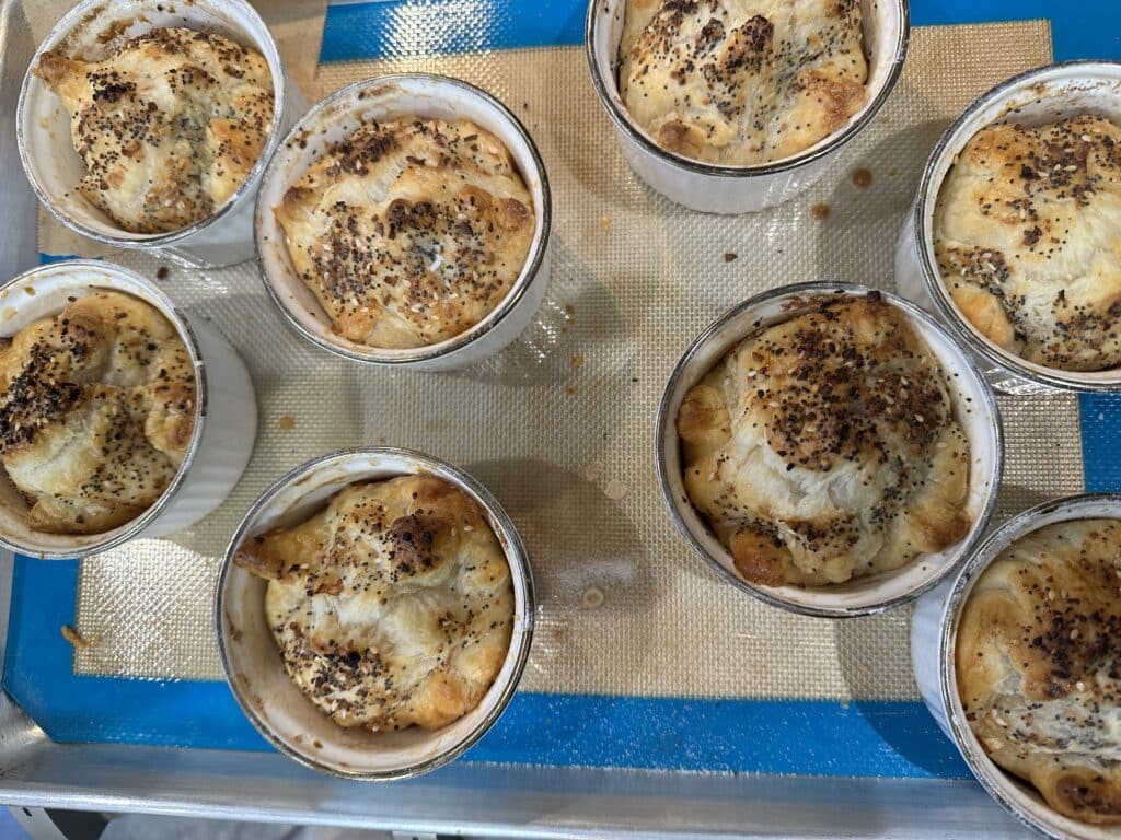 ramekins with what looks like cooked dough pinched together into a dumpling