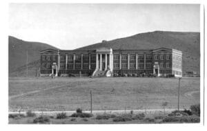 An old black and white building of a stately, large building with columns